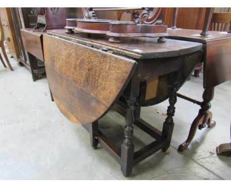 An 18th Century oak gate-leg dining table, turned supports, top 138cm long open  