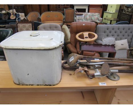 A bag of bygone golf clubs and an enamel bread bin