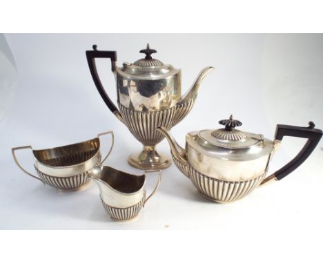Four piece hallmarked silver tea and coffee service of half lobed design with ebony handles and finials, Sheffield hallmarks 