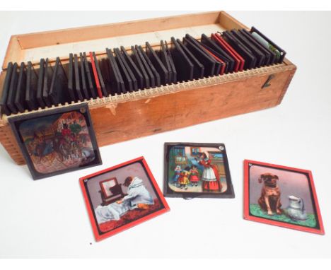 A collection of magic lantern slides - nursery rhymes and comic dog subjects, approximately 40 in a wooden box.