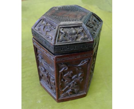 Carved hardwood hexagonal tea caddy, each panel carved with chinoiserie scene, hinged lid - 18cm tall 
