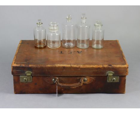 A vintage tan leather suitcase fitted brass twin-lever locks, 28½” wide; together with two cotton night gowns; &amp; five cle