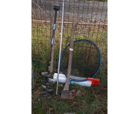 A Wedge axe, hand post auger and fishing net.