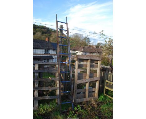 A metal 10 rung box section ladder with small hand rails.