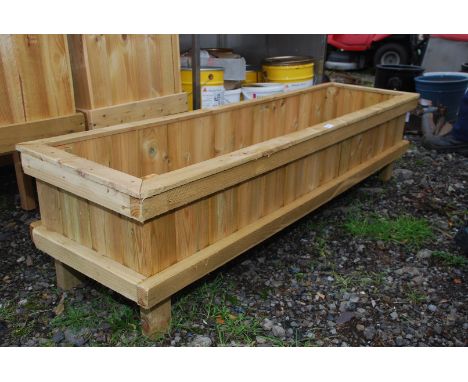 A large wooden trough/planter, 62 1/2" x 18" x 15" high.
