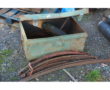 A metal trunk containing large wheel and axle, plus quantity of leaf springs.