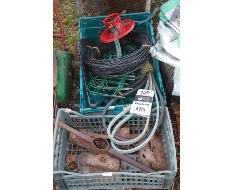 Two crates with 'V' belts, garden edging, Christmas tree stand, pick axe head, sledge hammer heads, etc.