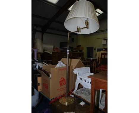A brass effect standard lamp with shade.