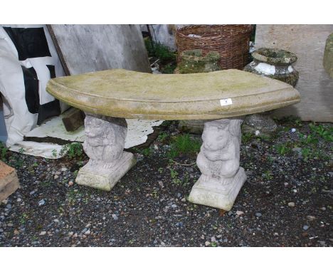 A concrete bench with squirrel/animal pillars, 40" wide x 18" high.