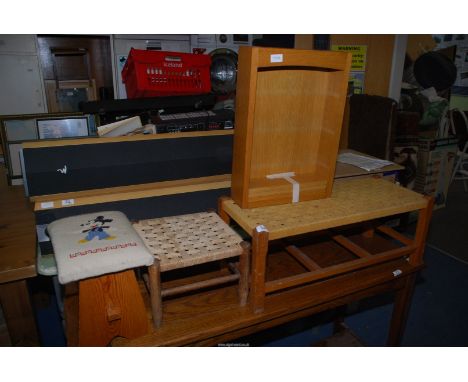 One long and two small footstools and a small shelf unit.