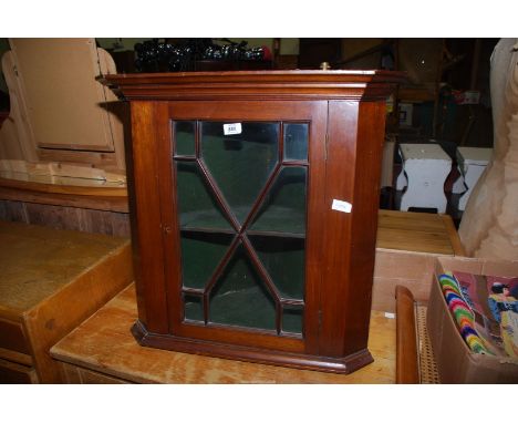 A Mahogany wall hanging Corner Cupboard with key and centre shelf. 23" wide x 25 1/2" high x 16 1/2" deep.