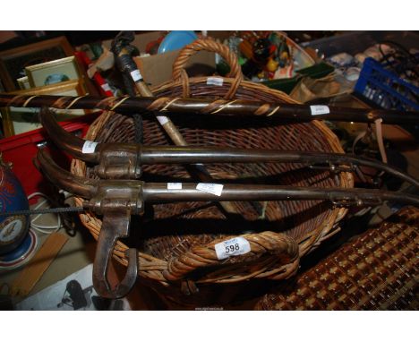 A log basket, pair of hiking sticks and Hanes Schooling whip.