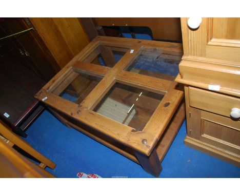 A glass and wood topped coffee table with lower shelf 31'' x 39'' x 16'' high.