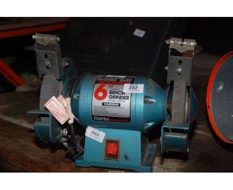 A Clarke 6" bench grinder (running at time of lotting).