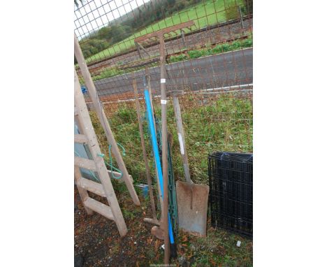 Garden tools, three rakes, shovel and electric fence posts, etc.