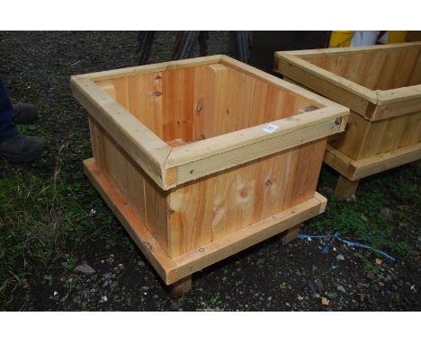 A wooden planter, 19" x 20 1/2" x 16" high.