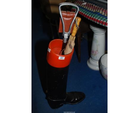 A Hunting boot Stick stand with umbrella and shooting stick.