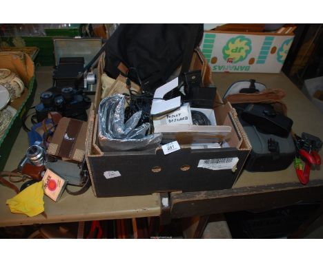 A box containing 2 slide presses, old camera, binoculars and photography equipment.