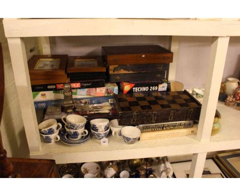 Shelf of board games, EPNS, boxed cutlery and ceramics.