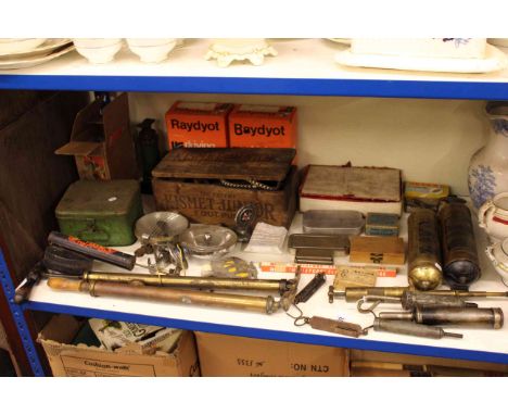 Shelf of automobilia interest including AA car badges, grease gun, fire extinguishers, lamps.