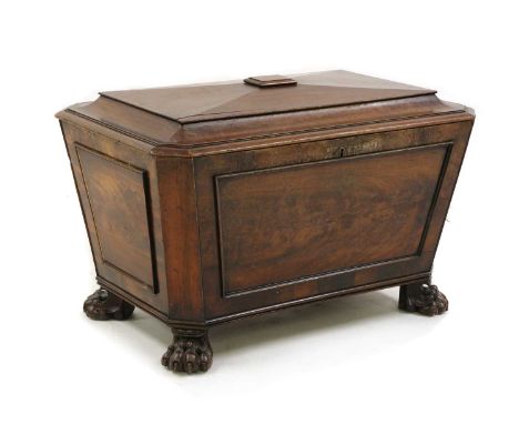 A Regency mahogany cellarette,19th century first quarter, large sarcophagus form, with divisioned interior on squat bun feet,