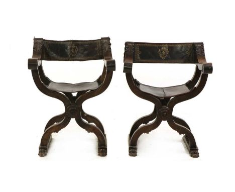 A pair of walnut Savonarola style X frame elbow chairs, 19th century, Spanish or Italian, each with carved detail, and gilt-t