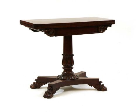 A William IV mahogany card table,early 19th century, the fold-over rectangular top on turned and carved pedestal and quatrefo