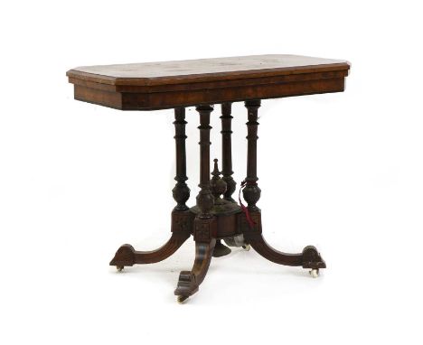 A Victorian figured walnut card table, late 19th century, the foldover top with inlaid detail on central column and scroll fe