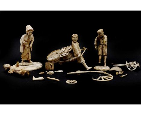 A Japanese ivory okimono, 19th century, fishman pulling cart with his catch, 16cm long 14cm hightogether with two other 19th 