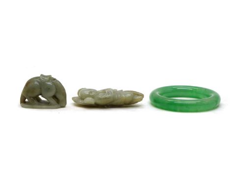 Two Chinese jade carvings, comprising: a plaque, of a boy carrying a lotus flower and leaf over his shoulder, 9cm high, and a