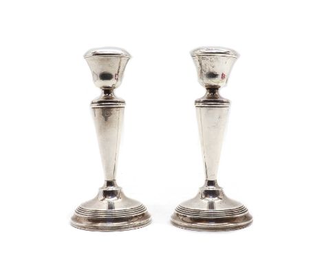 A pair of Elizabeth II silver candlesticks, by Joseph Gloster Ltd, Birmingham 1954, each with a tapering column and ring-turn