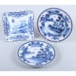 A Delft square dish, decorated cows and castle, 8" square, and a pair of Delft plates, decorated