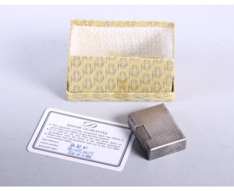 A mid 20th century French silver Dupont lighter, with abstract pattern decoration, complete with flints 