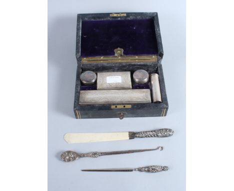 A silver handled page turner, a similar letter opener, a button hook and a Victorian leather vanity case with plated fittings