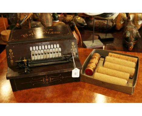 A late 19th century twenty-key "Gem Roller Organ", in painted wooden case, with six music cylinders 