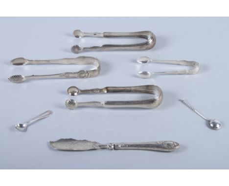 Four pairs of silver sugar tongs, two salt spoons, a silver butter knife and a cased set of twelve silver handled tea knives,