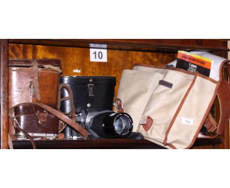 A Canon AE-1 SLR camera, with various Canon lenses and other photographic equipment, in a Leica canvas bag, together with a p