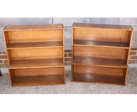 A pair of oak three shelf open bookcases and a similar, larger, bookcase, 54" wide 