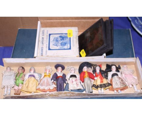 An assortment of magic lantern slides and six miniature Continental porcelain dolls 