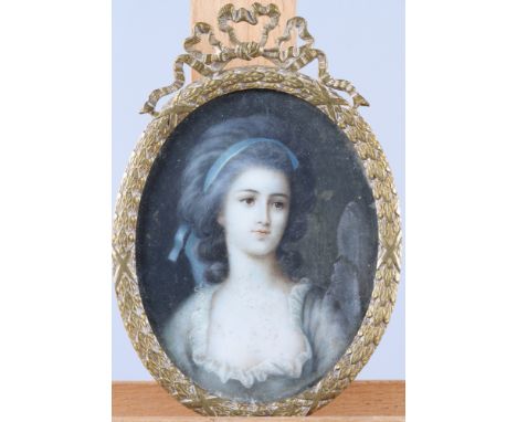Two oval portrait miniatures of 18th century women, in gilt metal and ebonised wooden frames, and a smaller circular portrait