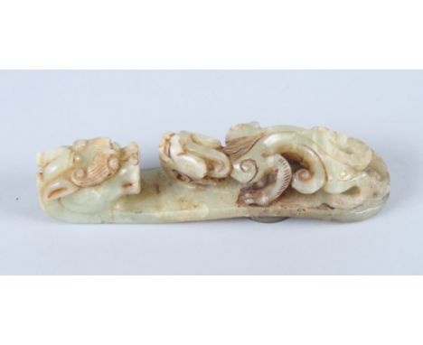 A 19th century, possibly earlier, carved mottled jade belt hook, in the form of a dragon with a salamander on his back, 5 1/2