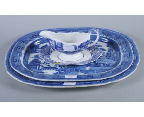 Two "Willow" pattern blue and white porcelain oval meat plates and a Spode "Italian" sauce boat and stand 
