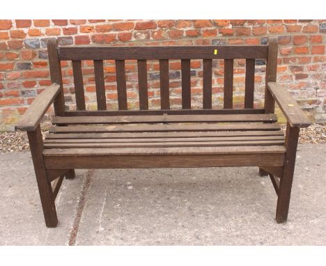 A slatted wooden garden bench by R A Lister, 52" long 