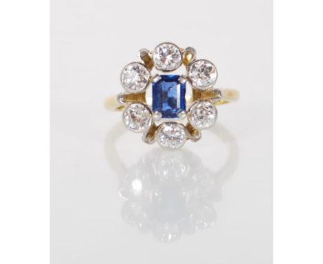 18ct white gold, sapphire and diamond cluster ring. The square cut sapphire within a halo of collet set diamonds totalling ap