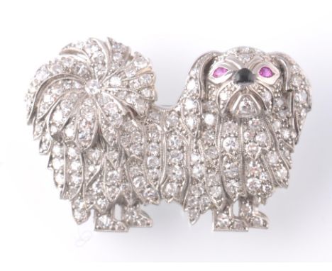 An 18ct white gold diamond and ruby novelty figural brooch. The novelty brooch being in the form of a Shih Tzu dog having pav