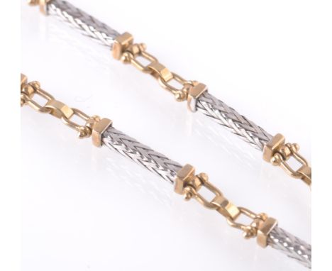 A 9ct white and yellow gold contemporary book chain necklace. The necklace having woven white gold spacers with yellow gold c