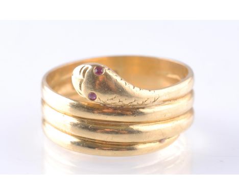 An early 20th century 18ct gold snake ring, London hallmarked, date letter gothic m for 1927. The snake with ruby eyes. Total