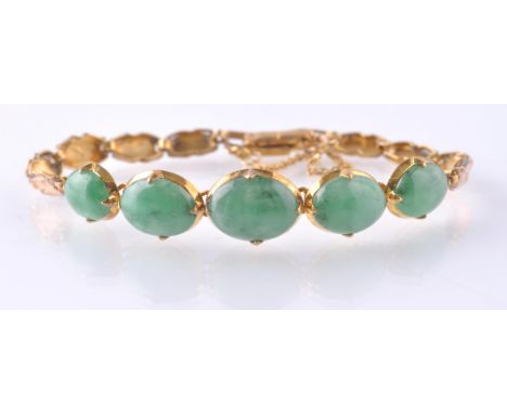 A gold and natural jade bracelet.&nbsp; The bracelet being set with 5 jade cabochons with certification for 'no treatment'. T