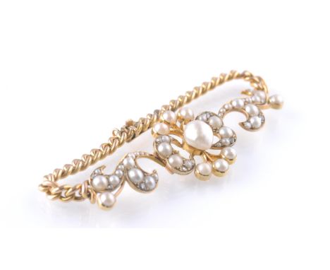 A 15ct gold pearl and diamond bracelet. The bracelet having a heart and lilly openwork design set with a central pearl (belie