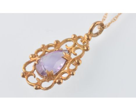 A 9ct gold necklace pendant having a pear cut amethyst in a scrolled setting. Weight 1.5g, together with a 15ct gold chain ne